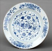 An 18th century Chinese blue and white charger The foliate decorated broad rim encompassing the
