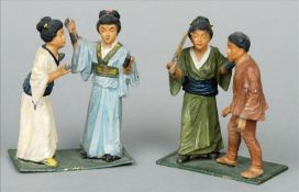 Two Japanese cold painted spelter figural groups One a couple, the other two ladies. 9 cms high. (2)