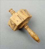 A 19th century Prisoner of War carved bone die Of hexagonal section with turned handle. 6.5 cms