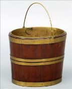 A 19th century brass bound mahogany bucket The brass loop handle above a brass liner and bound