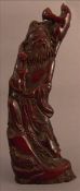 A Chinese carved horn figure of a sage Modelled in traditional costume, holding a young boy and