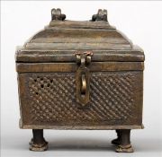 A Chinese archaistic style patinated bronze casket The domed hinged rectangular lid above panels