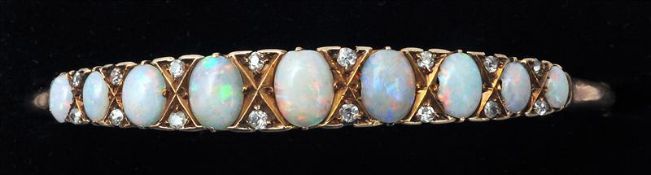 A Victorian unmarked gold, opal and diamond bracelet The band set with nine graduated opals