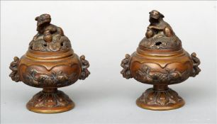 A pair of 19th century Chinese small bronze vases Each pierced domed removable lid mounted with a