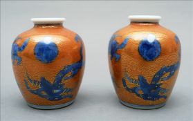A pair of Chinese porcelain miniature vases Each decorated with a figure and mythical beasts, on a