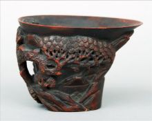 A 19th/20th century Chinese carved bamboo libation cup Of typical form, decorated with figures in