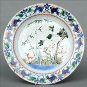 An 18th century Chinese famille verte charger The scrolling florally decorated broad rim above a