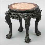 A 19th century Chinese hardwood table The shaped marble inset top above a carved frieze, standing on