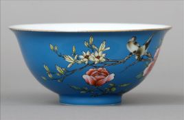 A Chinese porcelain bowl Decorated with birds within flowering boughs opposing calligraphic script