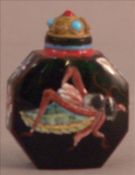 A Chinese enamel decorated snuff bottle With insects to either side. 6 cms high. Overall good,