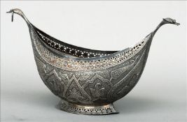 A 19th century Indian Kashmiri white metal begging bowl (Kashkul) Of typical navette form with