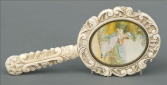 A 19th century Continental carved ivory dressing table mirror The oval plate opposing an inset