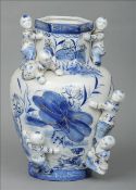 A Chinese blue and white vase Decorated with children and gilt detailing. 34 cms high. Some gilt
