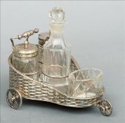 A Victorian novelty silver plated cruet stand Formed as an invalids carriage with cut glass