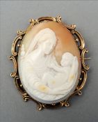 Two Victorian cameo brooches One carved with a mother and child, the other a gowned lady, each