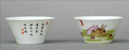 A pair of Chinese porcelain tea bowls Decorated with a doe and a deer resting amongst mushrooms, a