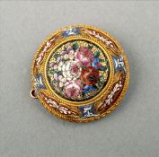 A small 19th century gold micro-mosaic brooch The domed body centred with a panel of blossoming