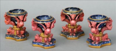 A set of four 19th century Royal Worcester table salts Each with marbled well, supported by a trio