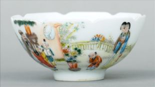 A Chinese porcelain bowl With lappet moulded rim, the body decorated with figures and children
