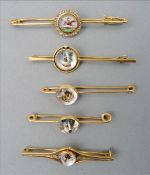 An unmarked gold and diamond set Essex crystal bar brooch The central cabochon carved with a jumping