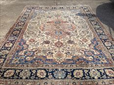 A Persian wool carpet The ivory field enclosing a central medallion with pendant palmettes within