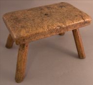 An 18th/19th century burrwood stool The rounded rectangular top on four splayed legs. 25.5 cms wide.