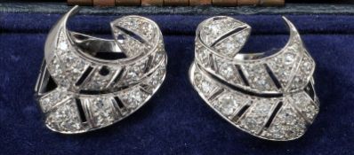 A pair of mid 20th century unmarked platinum and diamond ear clips Each formed as a diamond