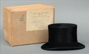 A James Locke & Co. black silk top hat Of typical form with a black felt band, housed in a cardboard