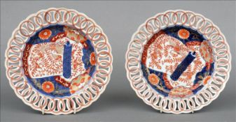 A pair of 19th century Imari plates Each with ribbon pierced borders, the centre decorated with a