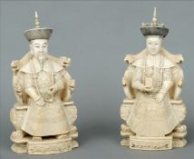 A pair of Chinese carved ivory figures Modelled as an emperor and empress seated on profusely carved