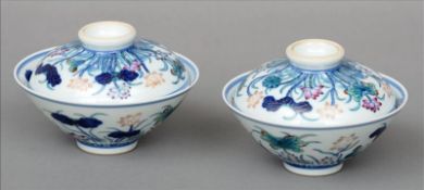A pair of Chinese porcelain rice bowls and covers Decorated with floral sprays, blue painted six