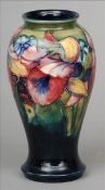 A Moorcroft Orchid and Spring Flowers pattern vase Of bulbous tapering form, the base signed and