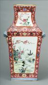 A Chinese porcelain vase Of rectangular section, decorated with floral vignettes flanked with mask