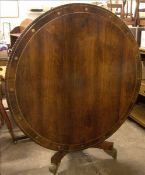 A Regency brass inlaid rosewood tilt-top breakfast table The gadrooned circular top inlaid with twin