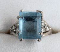 An Art Deco 18 ct white gold aquamarine set solitaire ring The emerald cut stone claw set and