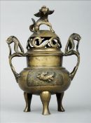 A late 19th century Chinese bronze censor The pierced domed removable lid surmounted with a shi-shi,