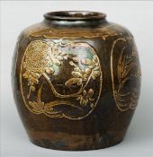 A large Chinese pottery brown glazed jar Decorated with four floral panels. 34.5 cms high. Generally