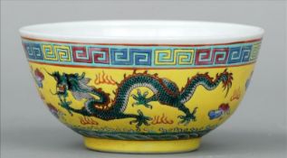 A small Chinese enamel decorated yellow ground bowl The top rim with Greek key decoration above