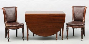 An Edwardian mahogany drop leaf table The top with twin D-end flaps above a shaped frieze,