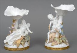 A pair of Victorian Copeland porcelain figural sweetmeats One formed as a fairy on a bed of fern
