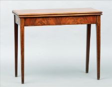 A 19th century line inlaid mahogany tea table The hinged folding top above a plain frieze,