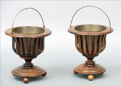 A pair of line inlaid mahogany jardinieres Each with a brass loop handle and brass liner above a