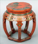 An Oriental red lacquered barrel form stand The shaped top decorated with pagodas amongst a lakeland