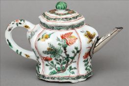 A Chinese Kangxi porcelain famille verte teapot and cover Decorated overall with floral sprays,