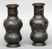 A pair of early 20th century Japanese patinated bronze vases The slender neck rim decorated with a