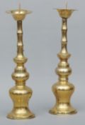 A pair of Oriental polished bronze temple pricket candlesticks Each engraved with lines of