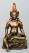 A fine 18th century Sino-Tibetan bronze seated Buddha Modelled holding a mouse and with red