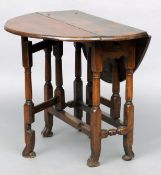An 18th century and later oak gateleg table The hinged double flap top above a single frieze drawer,