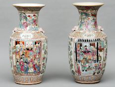 A pair of Chinese porcelain vases Each decorated with figural vignettes within fruit and floral