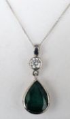 An 18 ct white gold emerald and diamond set pendant Approximately 2 carats, on an 18 ct white gold